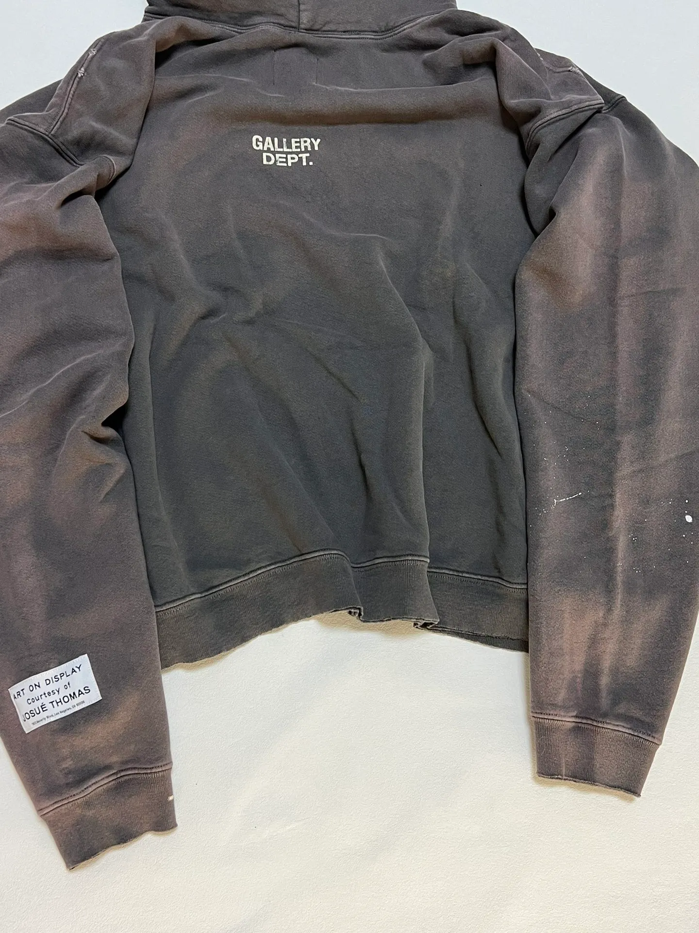 GALLERY DEPT. 90'S RECYCLE HOODIE WASHED BLACK 90'S washed hoodie with distressed eco-friendly slogans. Washed black S-XL. Ready-made garments are washed and dyed again. Multiple spots throughout the body are spray-faded. The ribs are cut and worn.